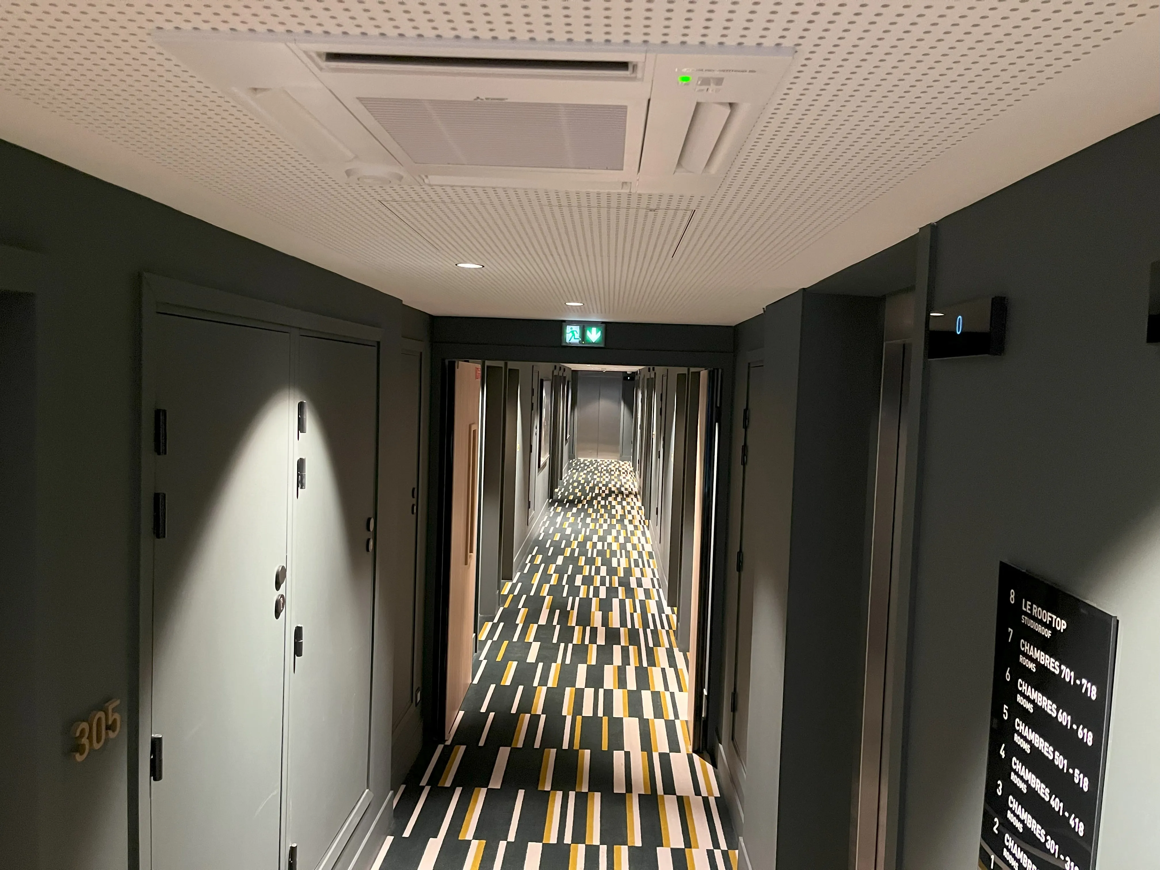 Couloir menant aux chambres avec cassette au plafond